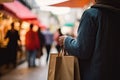 Close up of a man holding shopping bags in the city. Closeup rear view of a person holding shopping bag, AI Generated