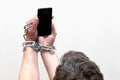 Close up Man holding smartphone with metal chain on white studio background. concept security Royalty Free Stock Photo