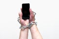 Close up Man holding smartphone with metal chain on white studio background. concept security Royalty Free Stock Photo