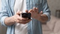 Close up man holding smartphone, typing on screen, browsing apps Royalty Free Stock Photo