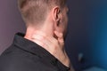 Close-up of a man independently kneading his neck and neck muscles long extensors of the neck. Neck pain