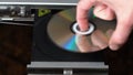 Close up of Man Inserting Disk into DVD Player