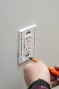 close up of man installing electrical outlet in wall in room of house Royalty Free Stock Photo