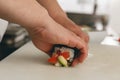 Close up of man japanese restaurant chef cooking sushi in the kitchen Royalty Free Stock Photo