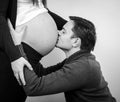 Close up of a man kissing the belly of his lovely pregnant wife Royalty Free Stock Photo