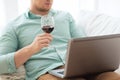 Close up of man with laptop and wine glass Royalty Free Stock Photo