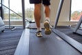 Close up of man legs walking on treadmill in gym Royalty Free Stock Photo