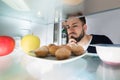 Close-up Of A Man Looking At Food Kept In Refrigerator Royalty Free Stock Photo