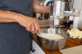 Close-up of a man mixing flour in a bowl at home