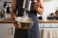 Close-up of a man mixing flour in a bowl at home