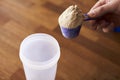 Close Up Of Man Mixing Protein Shake In Cup