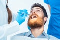 Close-up of a man with the mouth open during a medical procedure