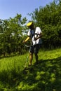 Man Mowing Green Wild Field. Royalty Free Stock Photo