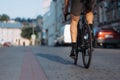 Close up of man with muscular legs riding bike on street Royalty Free Stock Photo