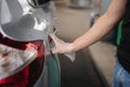 Close-up of man opening fuel tank cover on his car for refueling at gas station. Petrol prices concept Royalty Free Stock Photo