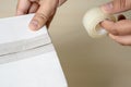 Close-up man packing box, adhesive tape indoors