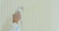 Close up of man painter paints the walls with paint spray gun. Airless spray painting. Royalty Free Stock Photo