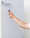 Close up of a man painting a wall in white Royalty Free Stock Photo