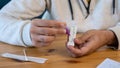 Close-up of man placing sample into a buffer dropper for seft detection of virus Royalty Free Stock Photo