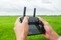 Man play Drone by remote control joystick with smartphone at green rice field Royalty Free Stock Photo