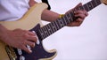 Close Up Of Man Playing Amplified Acoustic Guitar. Clip. Close-up view of hand playing guitar. Musician play on bass Royalty Free Stock Photo