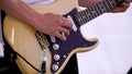 Close Up Of Man Playing Amplified Acoustic Guitar. Clip. Close-up view of hand playing guitar. Musician play on bass Royalty Free Stock Photo