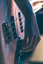 Close-up of a man playing the bass guitar. Royalty Free Stock Photo