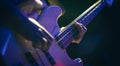 Close-up of a man playing the bass guitar. Royalty Free Stock Photo