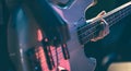 Close-up of a man playing the bass guitar. Royalty Free Stock Photo