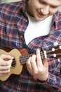 Close Up Of Man Playing Ukulele