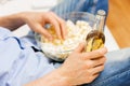 Close up of man with popcorn and beer at home Royalty Free Stock Photo