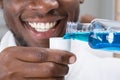 Close-up Of A Man Pouring Mouthwash Into Cap Royalty Free Stock Photo