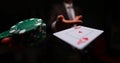 Close-up of man in presentable suit throwing playing card ace