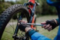 Close-up of a man pumping bicycle wheel in nature. Royalty Free Stock Photo