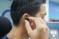 Man put true wireless earphone for music and phone working in office