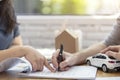 Close up, man putting signature on document loan contract, real estate purchase and new car. hands of woman sale represent point Royalty Free Stock Photo