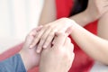 Close up of man putting wedding ring on woman finger Royalty Free Stock Photo