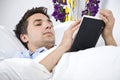 Close up of man reading a book on bed