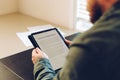 Close up man reading elecronic rental agreement on tablet. Royalty Free Stock Photo