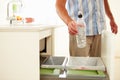 Close Up Of Man Recycling Kitchen Waste In Bin Royalty Free Stock Photo