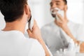 Close up of man removing shaving foam from face Royalty Free Stock Photo