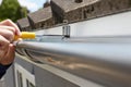 Close Up Of Man Replacing Guttering On Exterior Of House Royalty Free Stock Photo