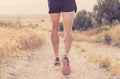 Close up of man running legs at sunset on a country road. Royalty Free Stock Photo