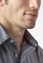 Close-up of man`s chin and jawline with facial hair beard stubble five o`clock shadow. Men`s personal care and grooming Royalty Free Stock Photo