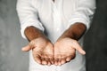 Close up of man`s cupped hands show something on white background. Palms up. High resolution product Royalty Free Stock Photo