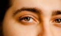 A close-up of a man\'s face, with his piercing brown eyes taking center stage Royalty Free Stock Photo