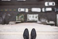 Close-up of man`s feet standing on the edge of the roof. Top view on man`s boots on the balcony of high building. Depression and Royalty Free Stock Photo