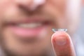 Man`s Finger With Contact Lens Royalty Free Stock Photo