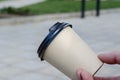 Close-up of a man`s hand with a bamboo coffee cup with lid Royalty Free Stock Photo