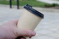 Close-up of a man`s hand with a bamboo coffee cup with lid Royalty Free Stock Photo